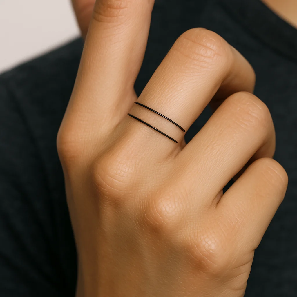 Fine double band with dash pattern tattoo in minimalist style on a finger